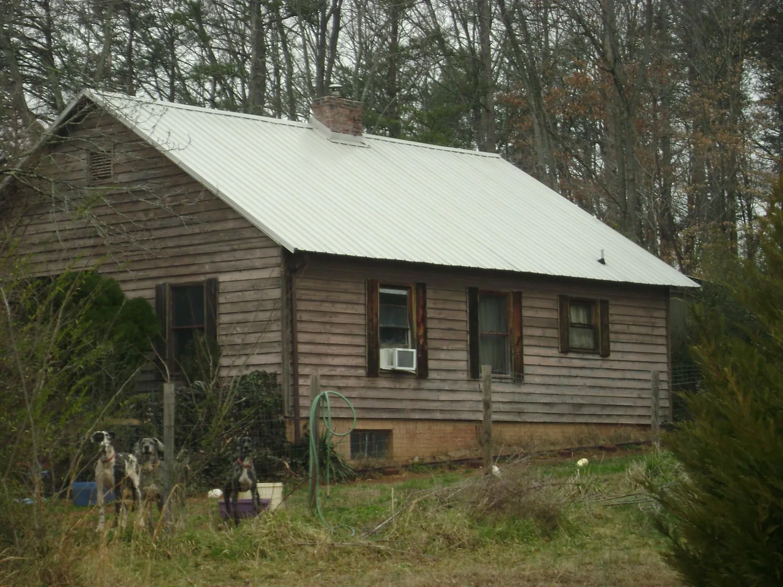 White metal roof on an old wood sided farmhouse, from a Metal Roof Installation job in Floral Park